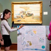 students discussing their poster with Jennifer Moss, WGVU